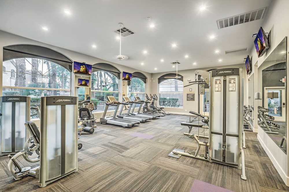 Fitness center with free weights at Calypso Apartments in Las Vegas, Nevada