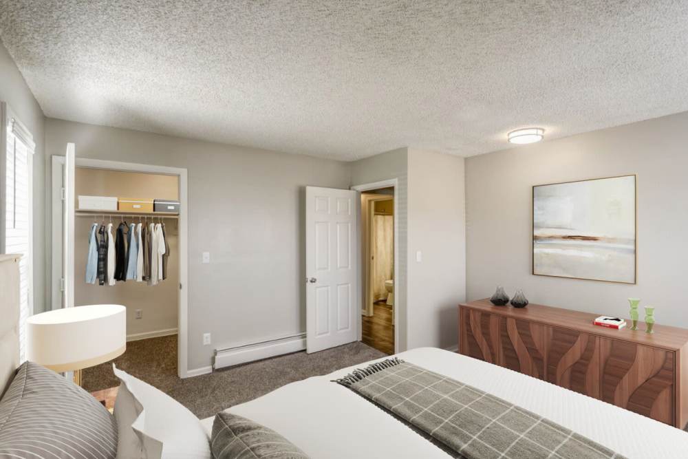 Decorated master bedroom with a large closet at Ascent at Lowry in Denver, Colorado