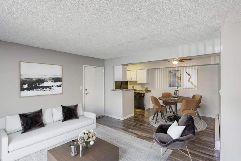 A furnished living room and dining room in an apartment at Ascent at Lowry in Denver, Colorado
