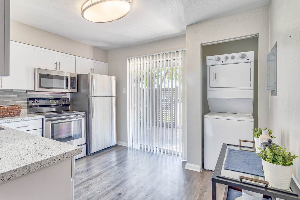Kitchen with outdoor access via a sliding door at Broadmoor Ridge Apartment Homes in Colorado Springs, Colorado