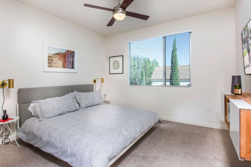 Bedroom with plush carpeting at Nineteen01 in Santa Ana, California