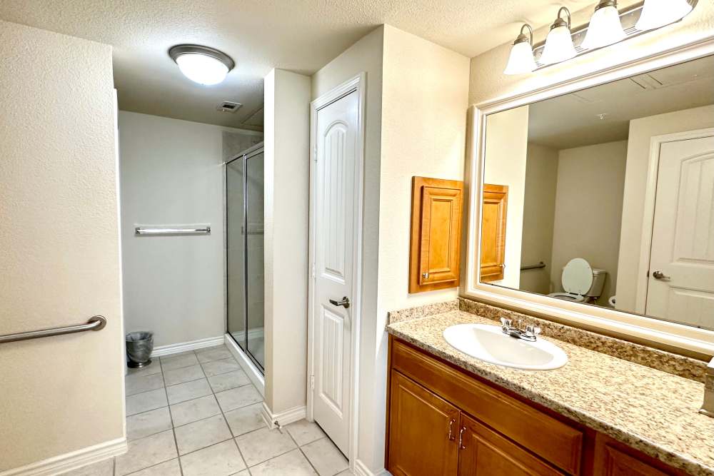 Bathroom with sleek fixtures tiled floors and a spacious shower