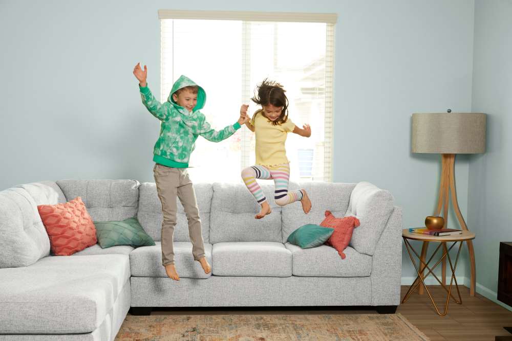 Kids jumping on the couch at BB Living Wellen Park in Venice, Florida