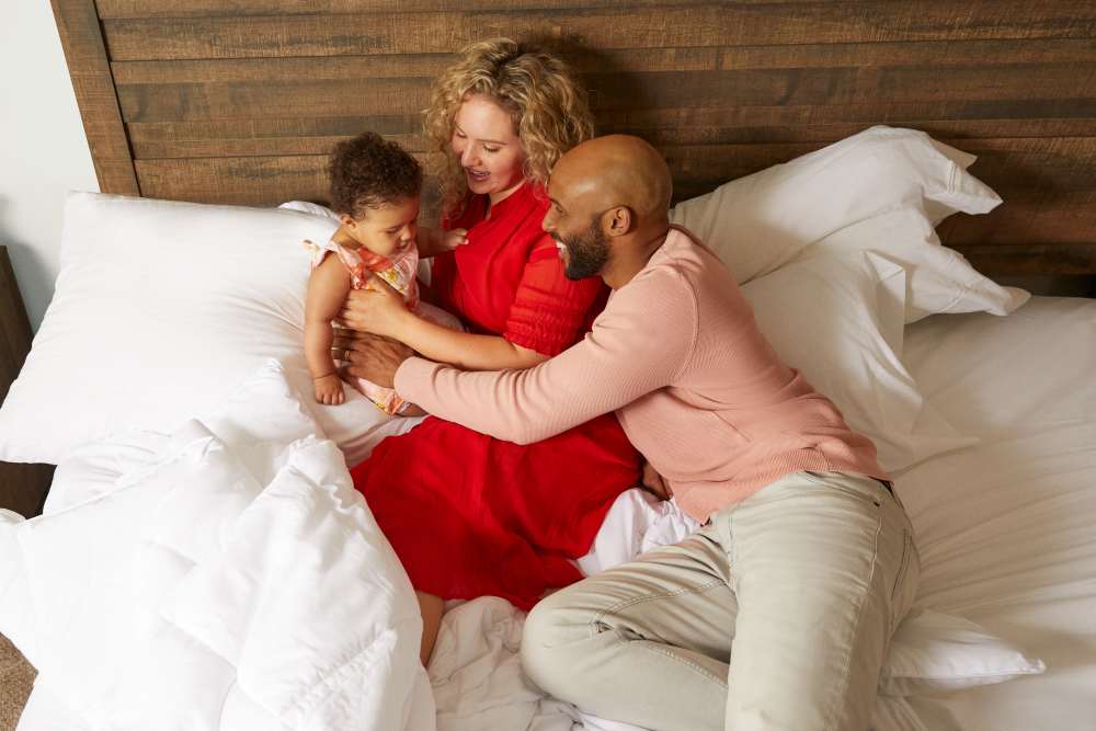 Residents playing with their kid in their bedroom at BB Living Wellen Park in Venice, Florida