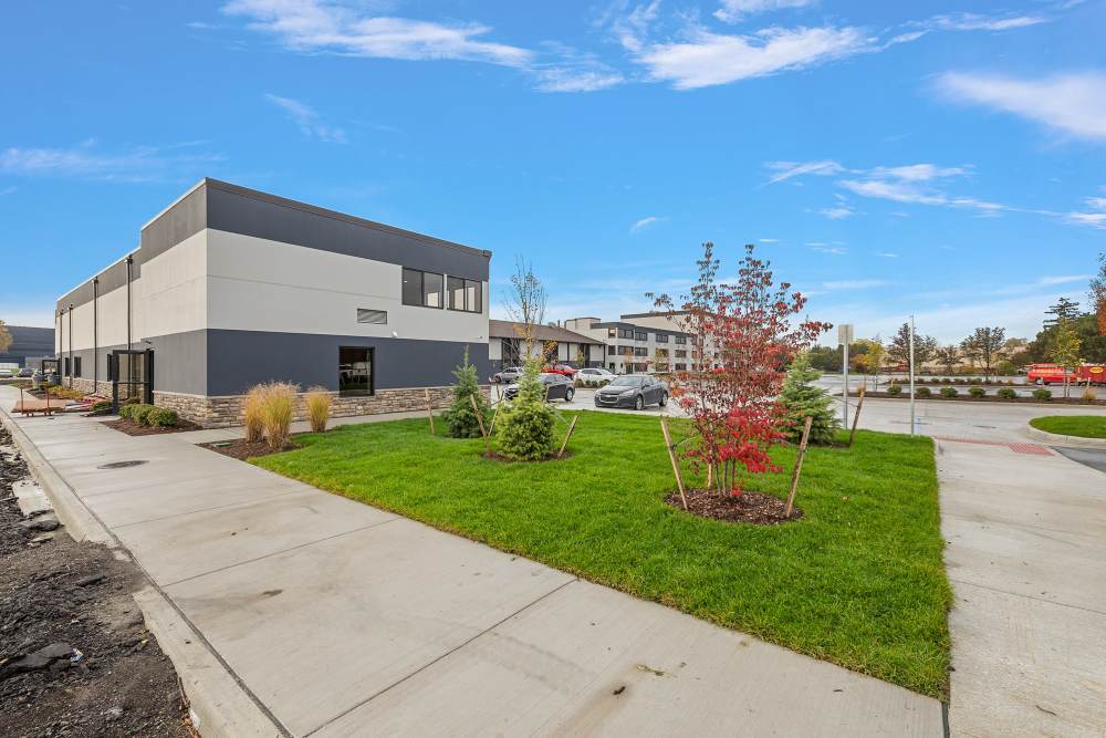 Ground level view of the apartments and grounds at The Block at Sterling Heights in Sterling Heights, Michigan