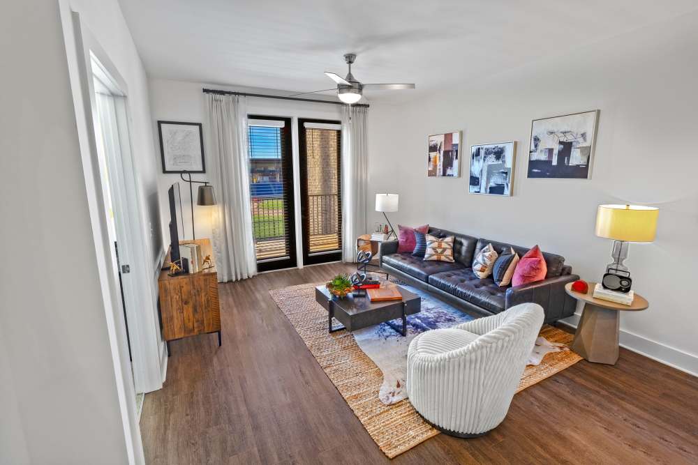 Model living room with an area rug at Fieldhouse Apartments in Lawrenceville, Georgia