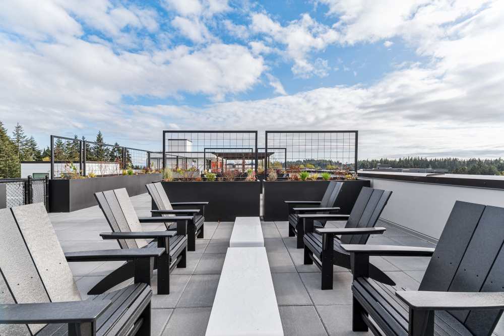 Outdoor seating and fire pits on the roof deck at Traxx Apartments in Mountlake Terrace, Washington 