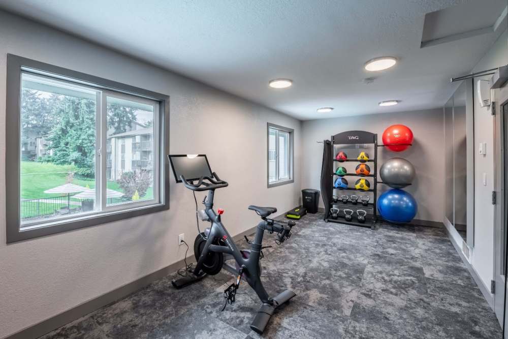 Fitness center with various workout machines and equipment at Terra Apartment Homes in Federal Way, Washington