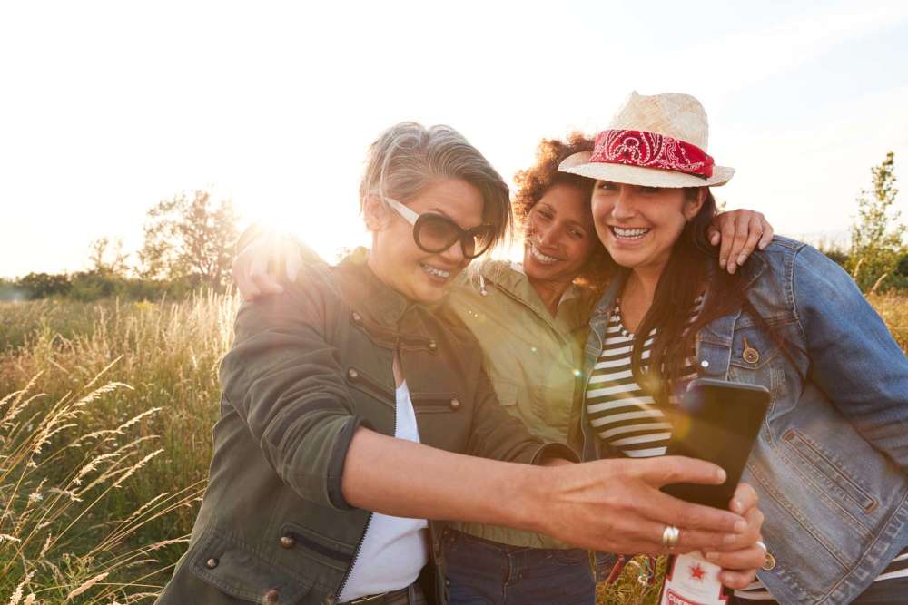 Resident taking a selfie with younger family members at Netherbay at Bay Shore in Bay Shore, New York
