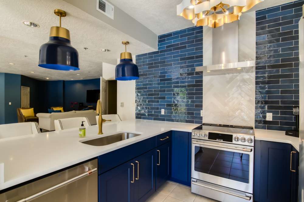 Clubhouse kitchen with blue accents at Huning Castle Luxury Apartments in Albuquerque, New Mexico