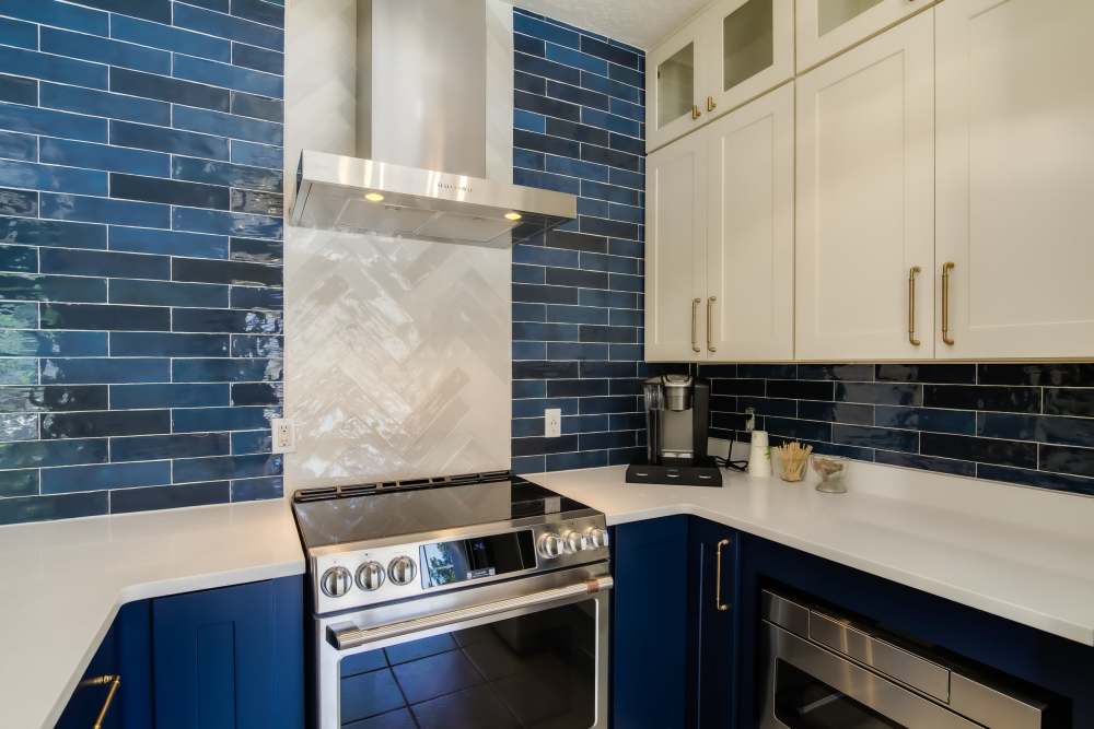 Kitchen with blue accents at Huning Castle Luxury Apartments in Albuquerque, New Mexico