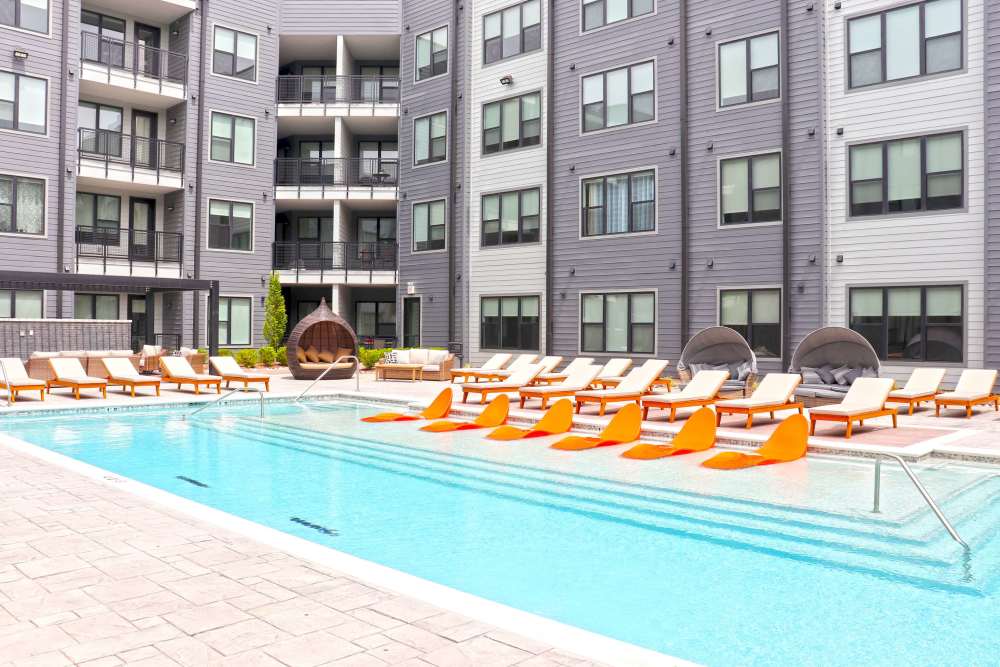 Swimming pool with lots of lounge chair seating at The Flats at Dorsett Ridge in Maryland Heights, Missouri