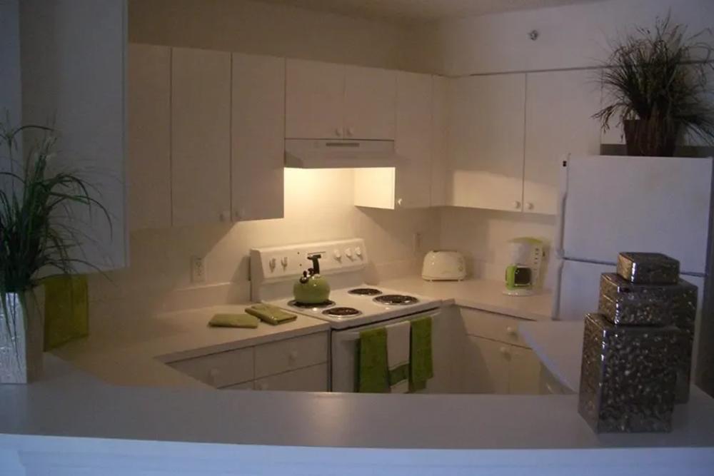 White cabinets in an apartment kitchen at Bernwood Trace in Fort Myers, Florida