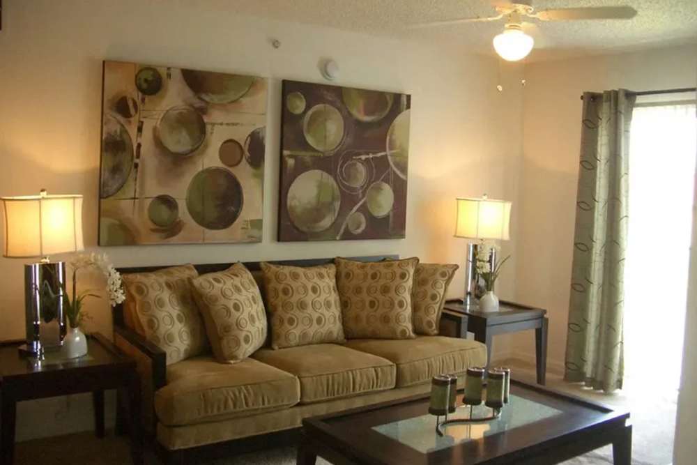 A couch, side tables and coffee table in a model living room at Bernwood Trace in Fort Myers, Florida