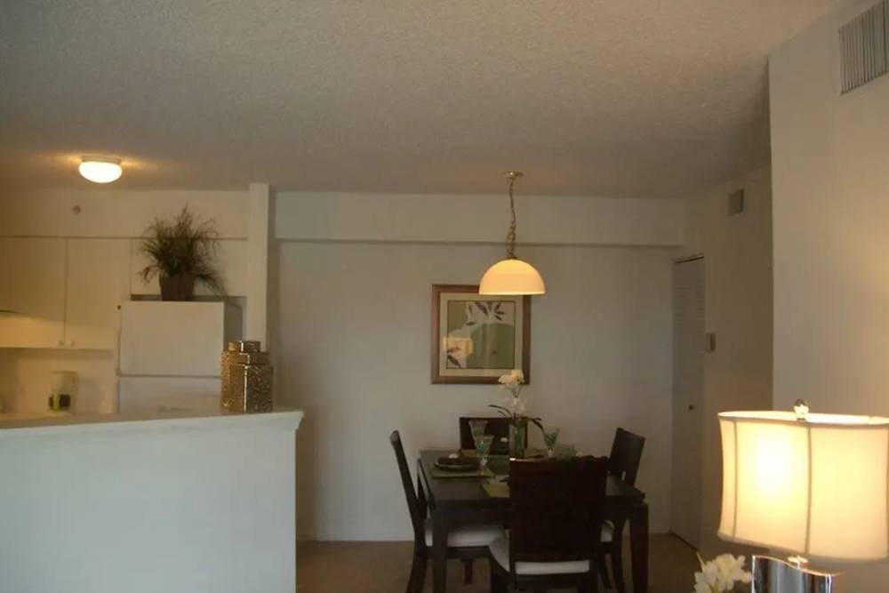 An apartment kitchen and dining room at Bernwood Trace in Fort Myers, Florida