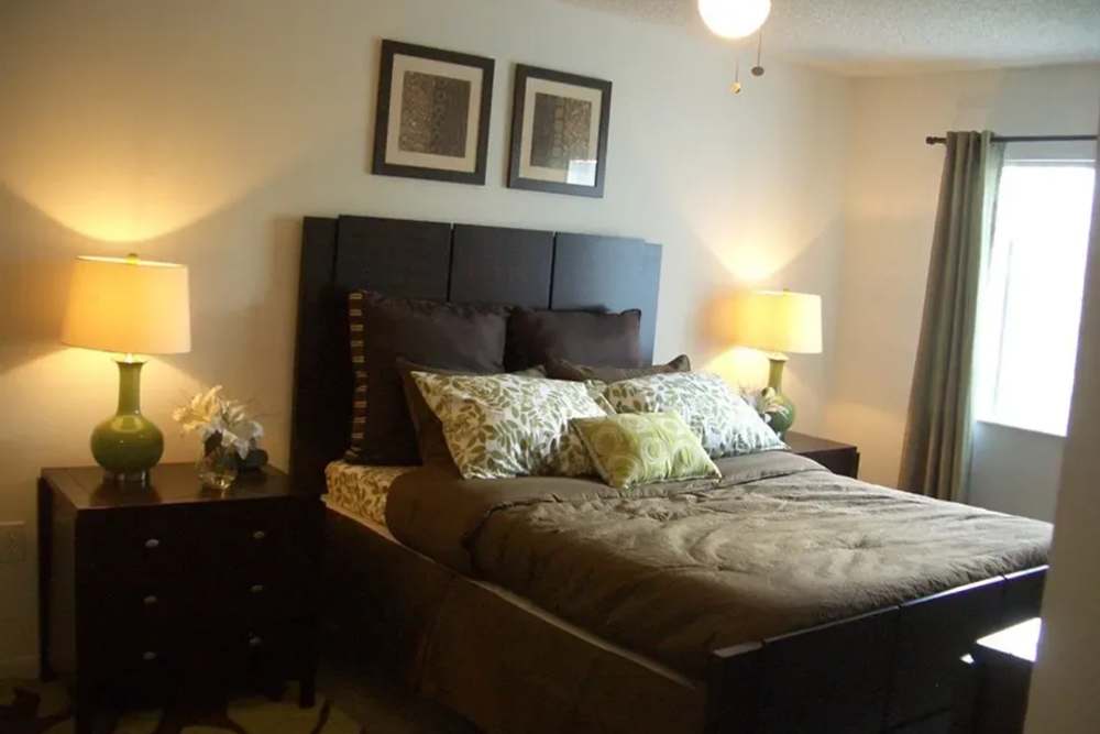 A spacious, furnished apartment bedroom at Bernwood Trace in Fort Myers, Florida