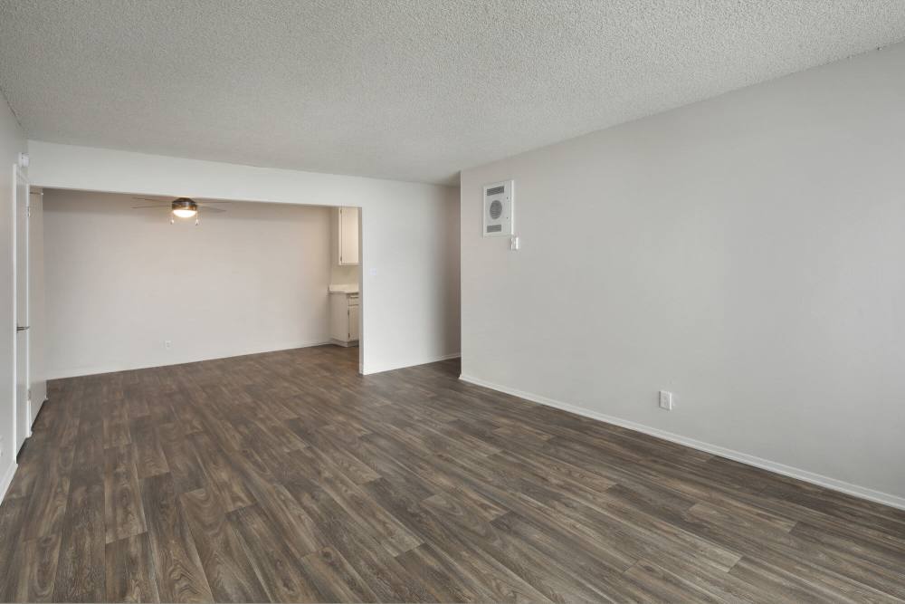 Large open living space with wood-style flooring at Mar at National City in National City, California