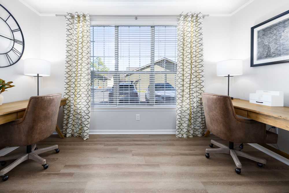 Two desks on either side of an apartment window at Arbors at Cahaba River in Birmingham, Alabama