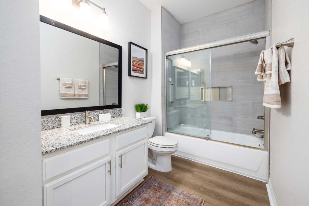 An apartment bathroom with a bathtub at Arbors at Cahaba River in Birmingham, Alabama