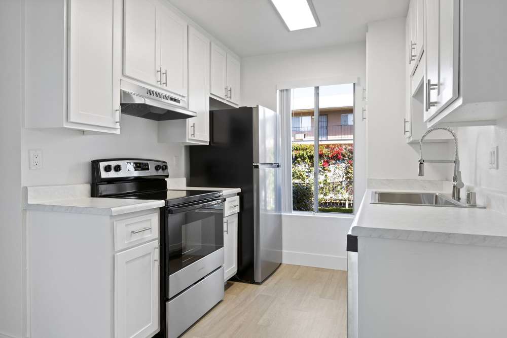Kitchen with stainless-steel appliances at Valle at 9209 Kenwood in Spring Valley, California