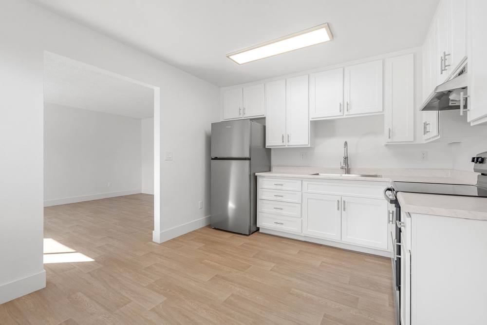 Kitchen with wood-style flooring at Valle at 9209 Kenwood in Spring Valley, California