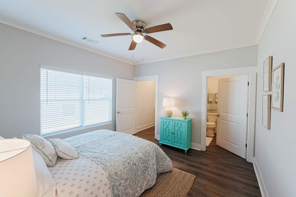 Cozy bedroom with ceiling fan at Beverly Villas in Brunswick, Georgia