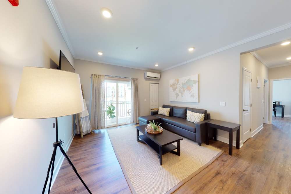 Living room with wood floors at Coastal Club Apartments in Brunswick, Georgia