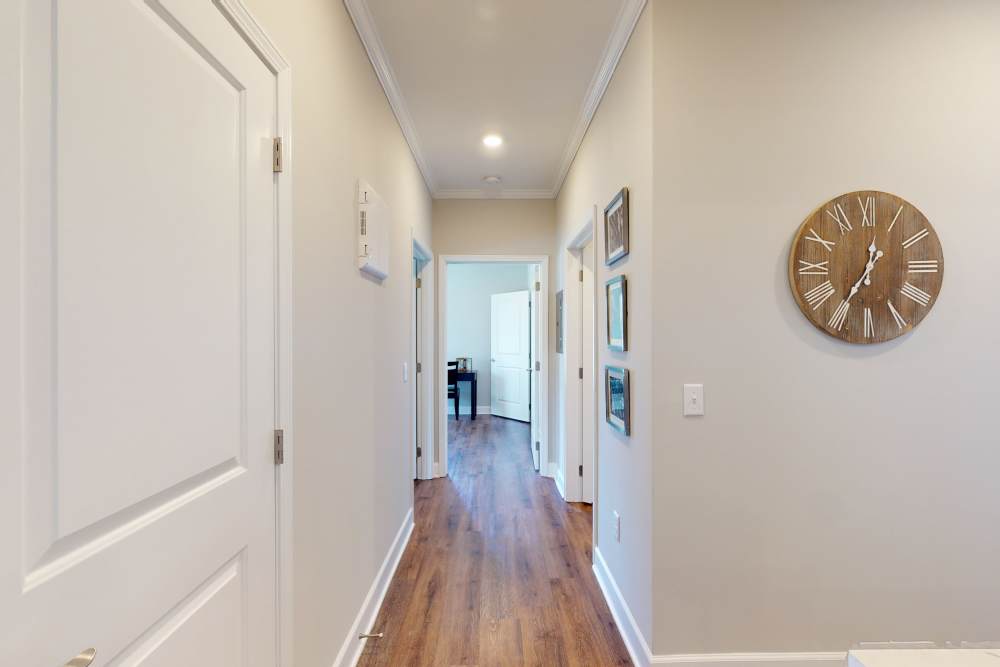 Hallway leading to bedrooms and laundry facilities in a model home at Coastal Club Apartments in Brunswick, Georgia
