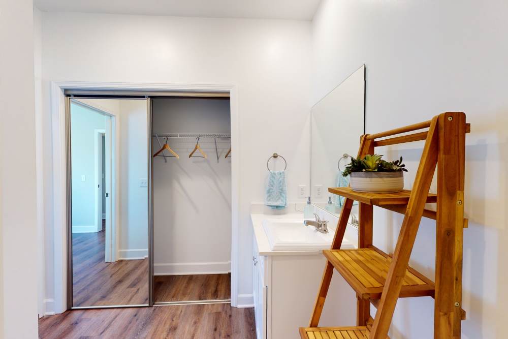 Bathroom and slider-door closet at Coastal Club Apartments in Brunswick, Georgia