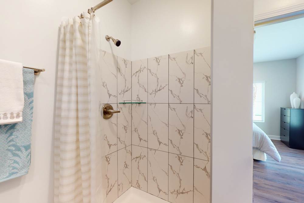 Shower and bathtub combo in a model home at Coastal Club Apartments in Brunswick, Georgia