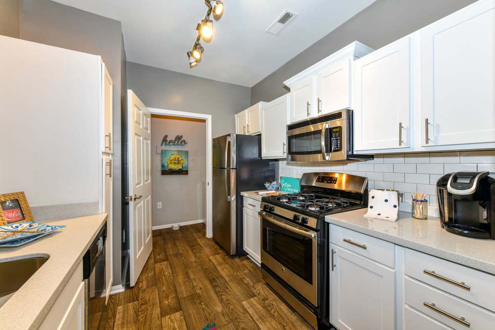 Couple whipping up a fresh meal in their modern kitchen at Retreat at Johns Creek in Duluth, Georgia