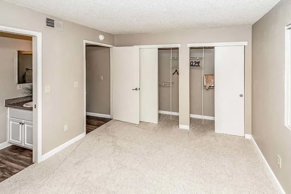 Peaceful bedroom with carpet flooring, walk-in closet and attached washroom at Woodlake Close in Sacramento, California