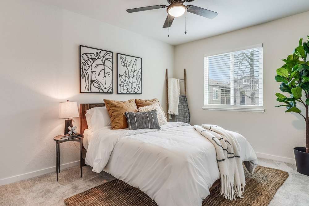 Bedroom with vinyl flooring and ceiling fan at Trails at 2112 in Modesto, California
