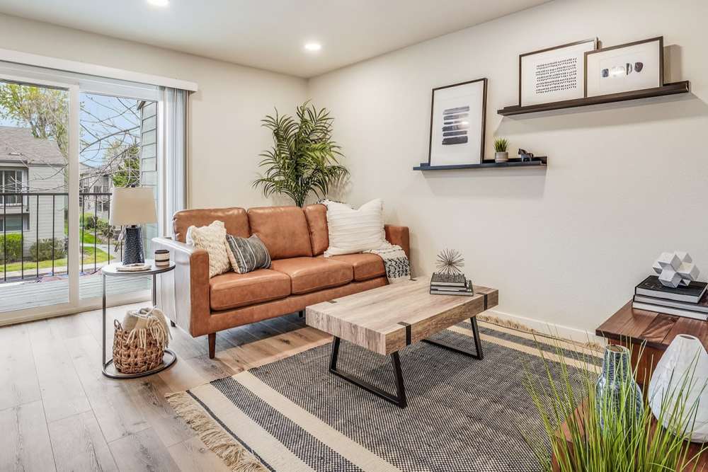 Cozy living room with hardwood floors and access to private patio at Trails at 2112 in Modesto, California