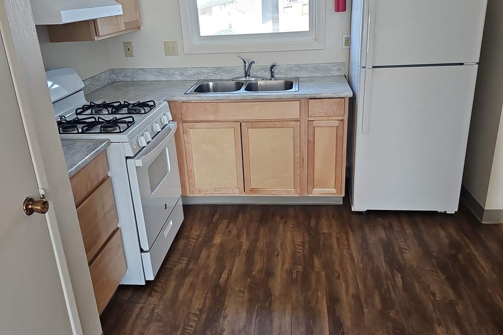 Kitchen with white appliances at Jewel Lake Villa in Anchorage, Alaska