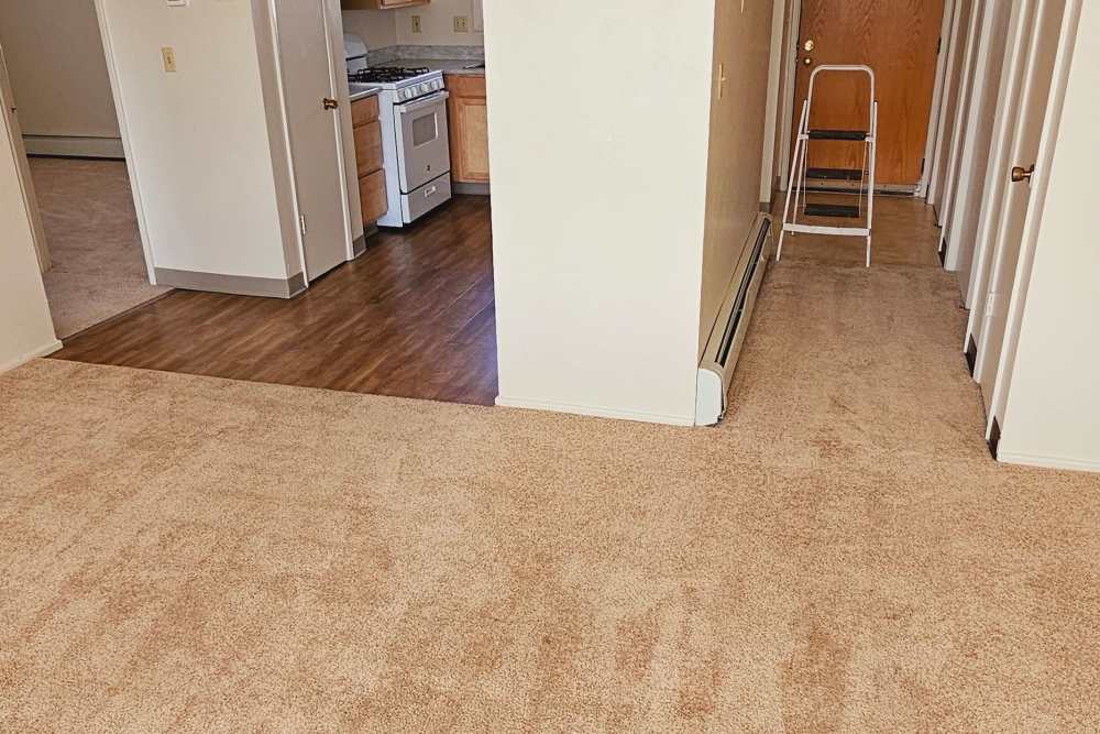 Open layout carpeted living room with plenty of room at Jewel Lake Villa in Anchorage, Alaska
