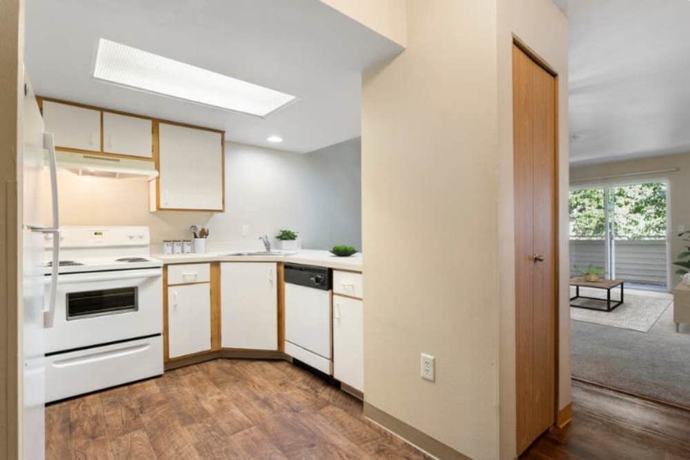 Kitchen with wood-style flooring at Brentwood Apartments in Portland, Oregon