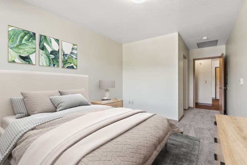 Bedroom with carpet at Ventura Park Plaza Apartments in Portland, Oregon