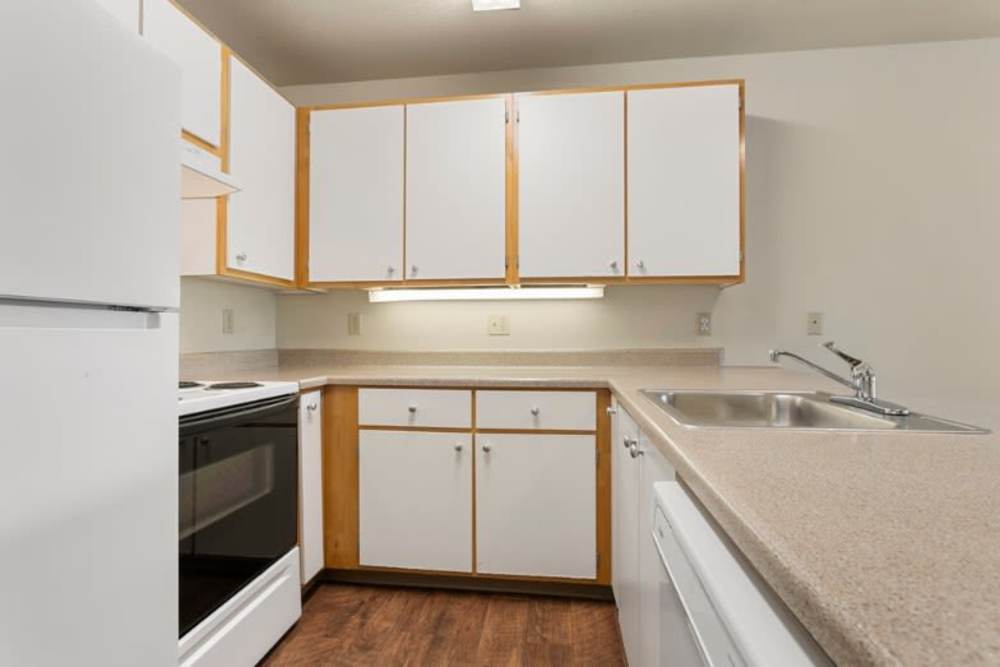 Fully-equipped kitchen at Ventura Park Plaza Apartments in Portland, Oregon
