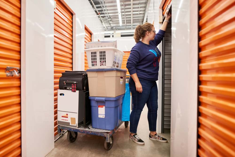 A woman moving her boxes to her unit at Cedartree Management Company