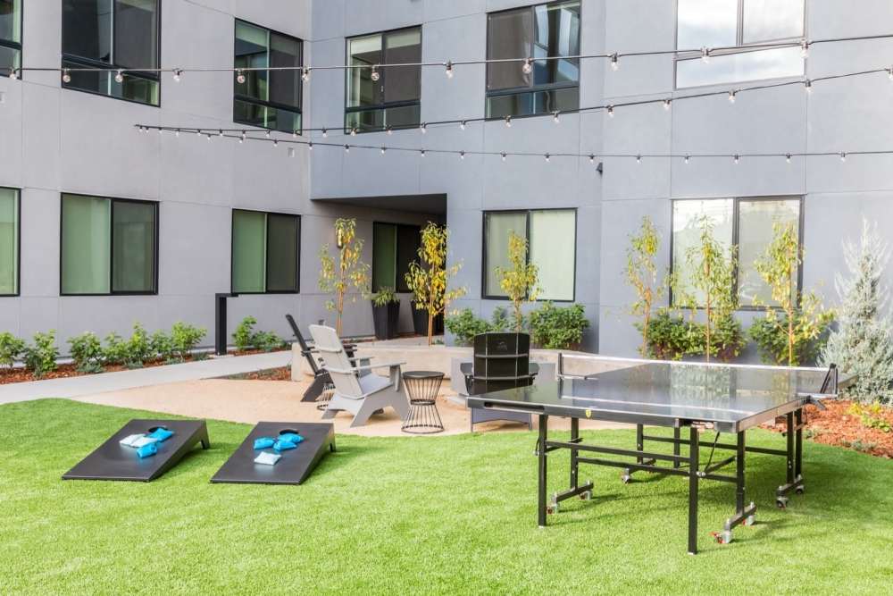 Outdoor community area with a ping pong table at Reno Experience District in Reno,