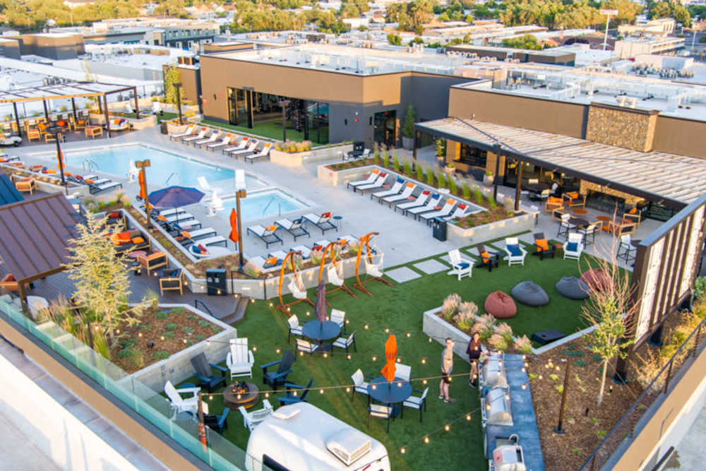 Beautiful amenity deck with pool and lawn seating at Reno Experience District in Reno, Nevada