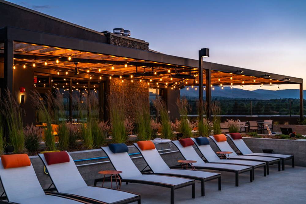 Lounge chairs by the resort-style swimming pool at Reno Experience District in Reno,