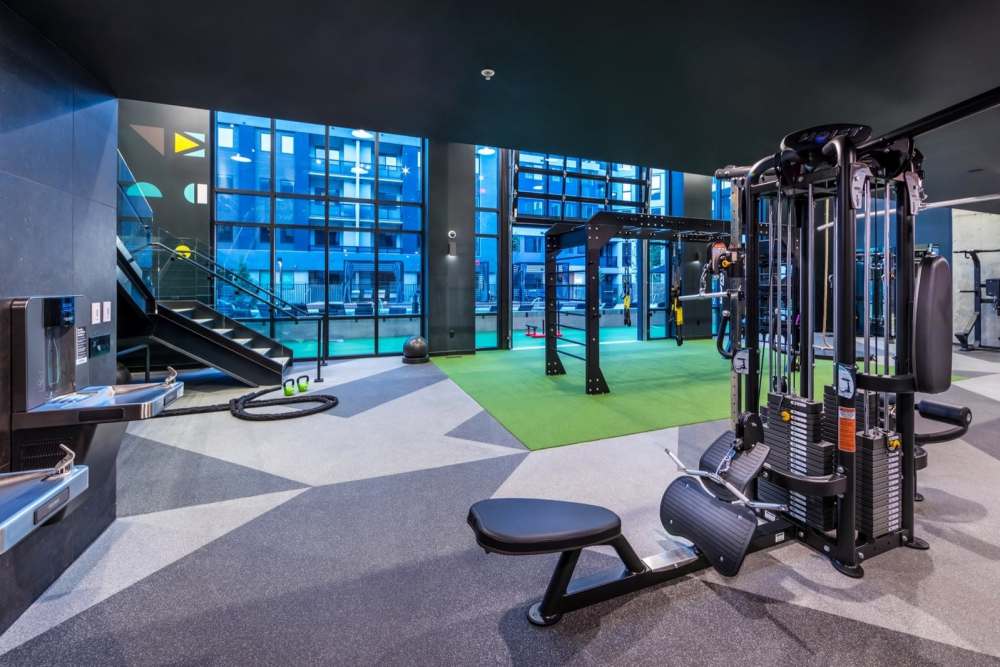 Modern gym fitness room with large windows and treadmills at Reno Experience District in Reno,