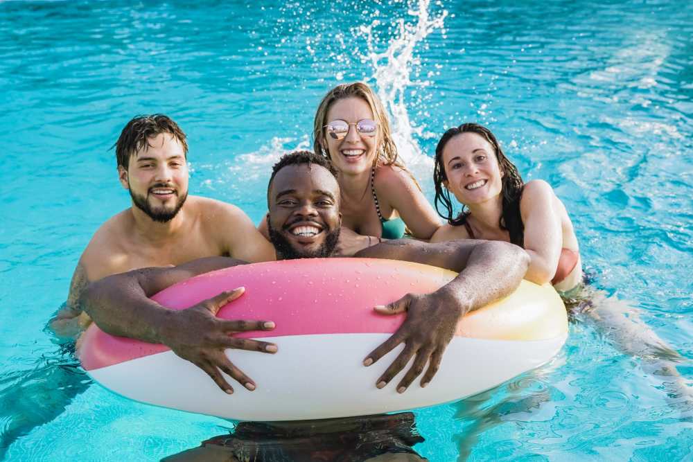 A group of friends in the swimming pool at Arbors at Cahaba River in Birmingham, Alabama