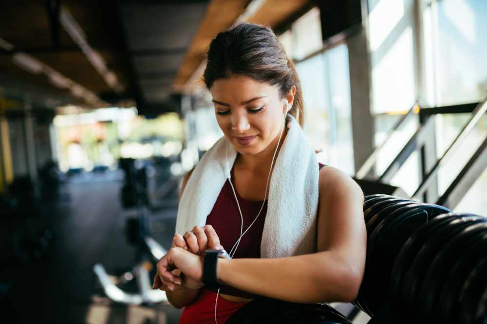 A woman looking at her watch after a workout at Arbors at Cahaba River in Birmingham, Alabama