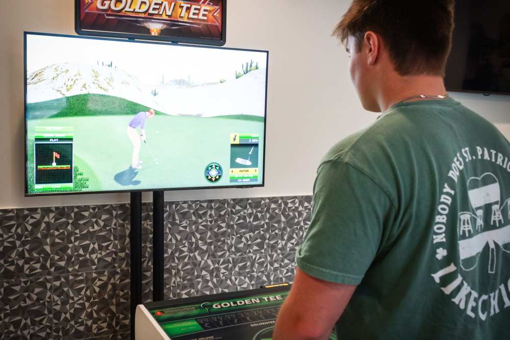 Resident playing Golden Tee at College Town Oxford in Oxford, Mississippi