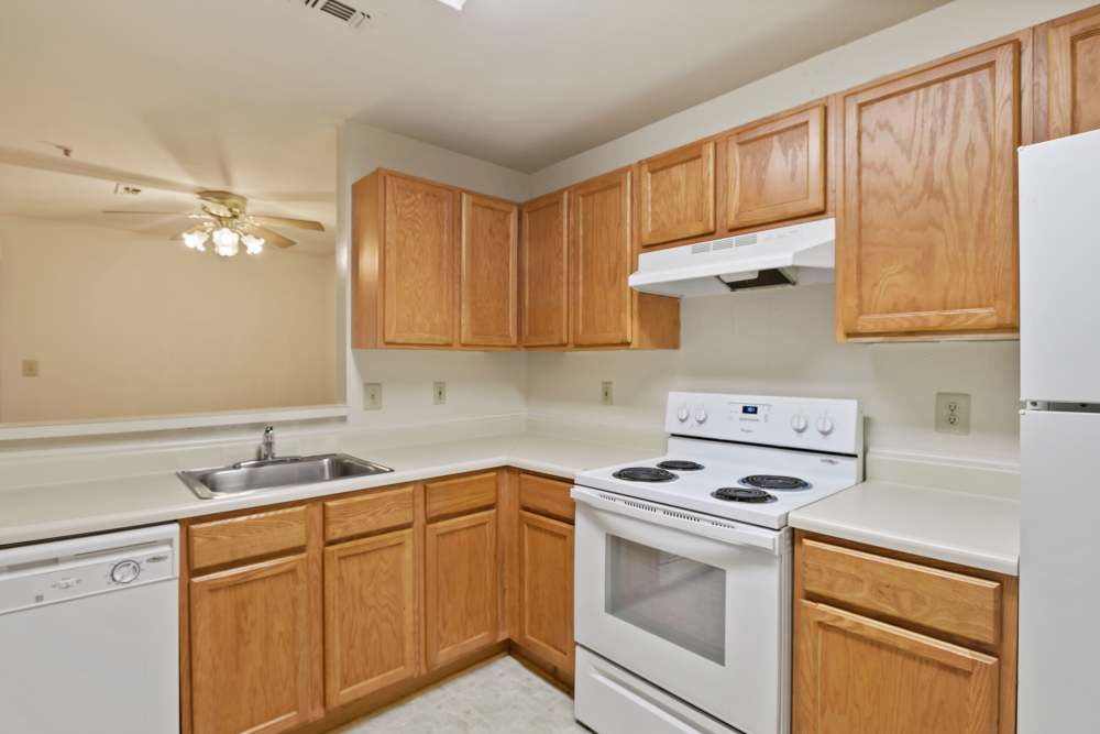Model kitchen with wood cabniets at WOODS OF MARLTON in Upper Marlboro, Maryland