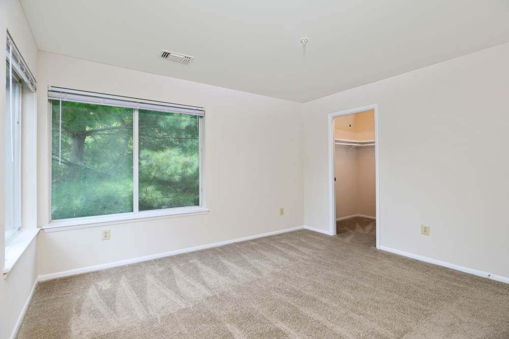 Modern bedroom with large windows at WOODS OF MARLTON in Upper Marlboro, Maryland