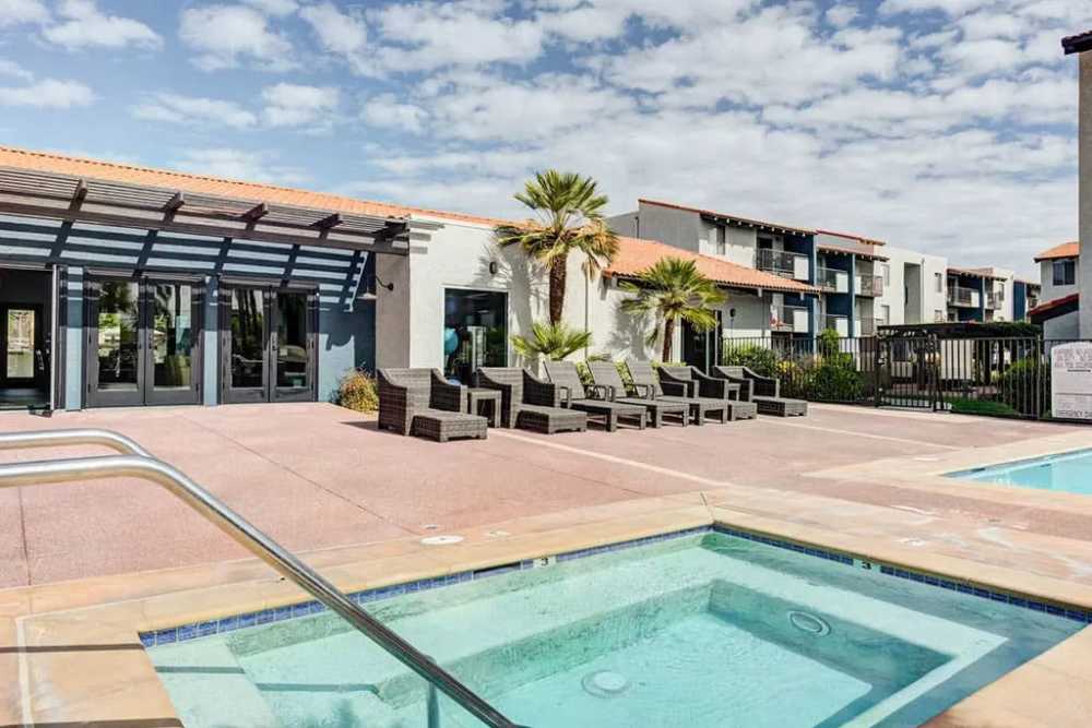 Studio Apartments In Chatsworth, CA - Waterstone At Chatsworth Apartments - Gated Pool With Spa/Hot Tub, Lounge Chairs, and View of Clubhouse